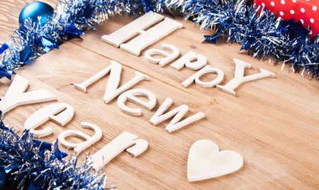 Wood inscription Happy New Year close up with snow. Greeting card
