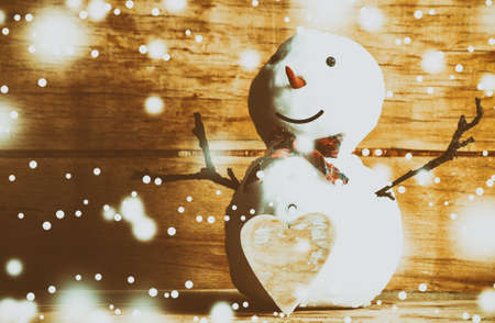 Snowman on wood desk. Greeting card. Christmas backgroundの写真素材