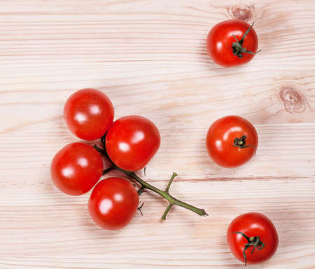 Fresh cherry tomatoes on rustic wooden background. Food ingredientsの写真素材
