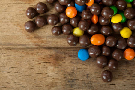 Multi color candy close up on wood desk. Sweetの写真素材