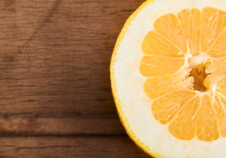 Fresh ripe pomelo isolated on wood desk. Fruits