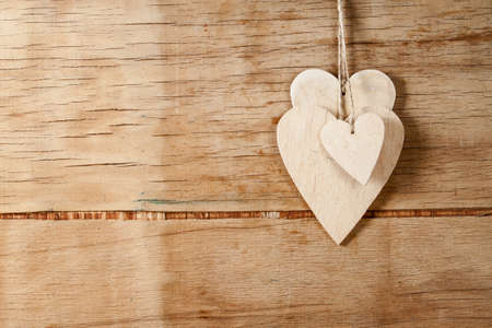 Wood hearts on old wood background. Greeting card. Valentine's day background.の写真素材