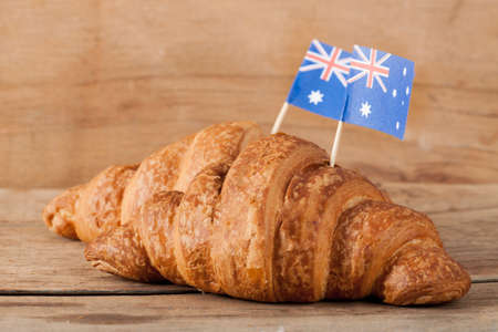 Fresh croissant and australian flag on wood desk. Greeting cardの写真素材