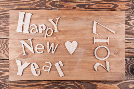 Wood inscription Happy New Year close up with snow. Greeting cardの写真素材