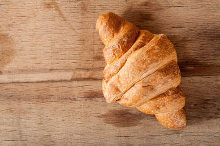 Fresh croissant on wood desk. Home baking. Sweetの写真素材