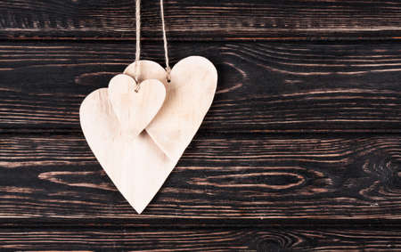 Wood hearts on old wood background. Greeting card. Valentine's day background.の写真素材