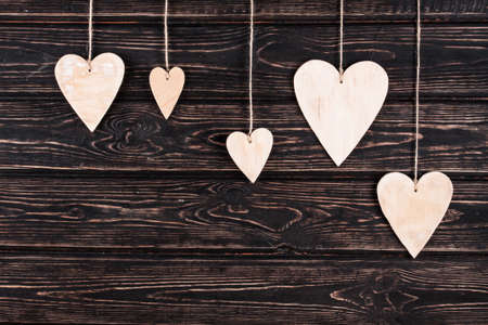 Wood hearts on old wood background. Greeting card. Valentine's day background.