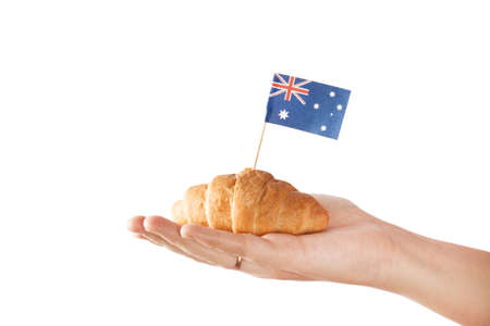 Fresh croissant and australian flag isolated on white backgroundの写真素材