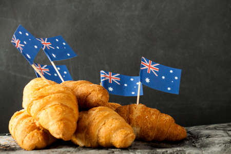Fresh croissant and australian flag on wood desk. Greeting cardの写真素材