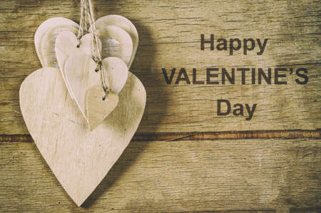 Wood hearts on old wood background. Greeting card. Valentine's day background.の写真素材