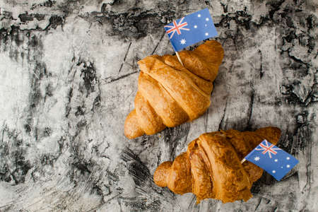 Fresh croissant and australian flag on wood desk. Greeting cardの写真素材