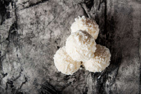 Candy with coconut and nuts on scratched background. Sweetsの写真素材