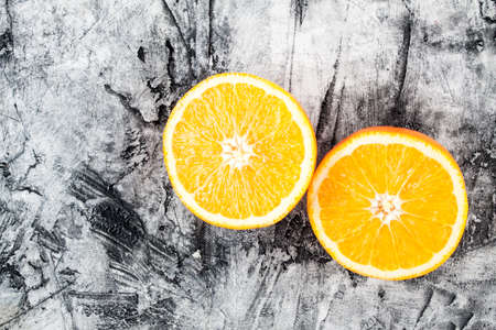 Ripe fresh orange close up on scratched backgroundの写真素材