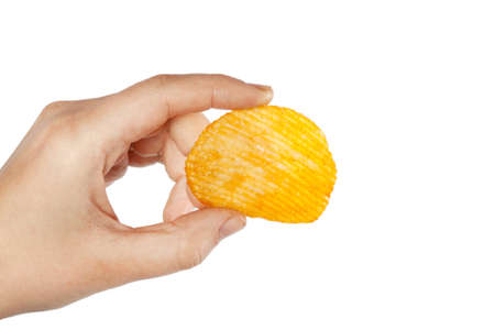 Potato chips grooved in hand isolated on white backgroundの写真素材