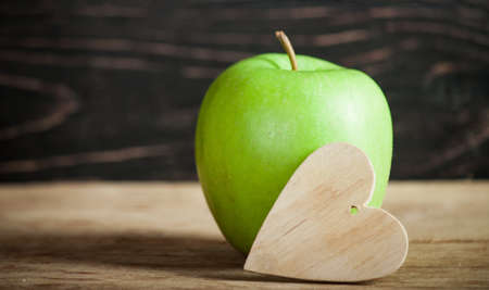 Fresh apple with measuring tape  on wood deskの写真素材