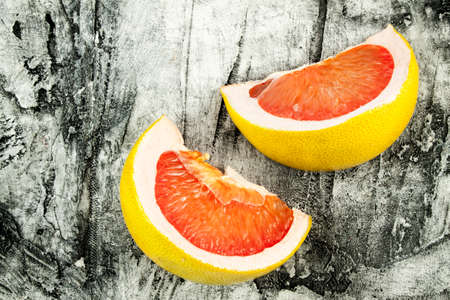 Ripe fresh pomelo close up on wood deskの写真素材