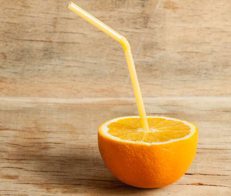 Ripe fresh orange close up on woo deskの写真素材