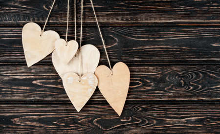 Wood hearts on old wood background. Greeting card. Valentine's day background.の写真素材