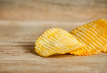 Fried potato chips corrugated on wood desk. Foodの写真素材
