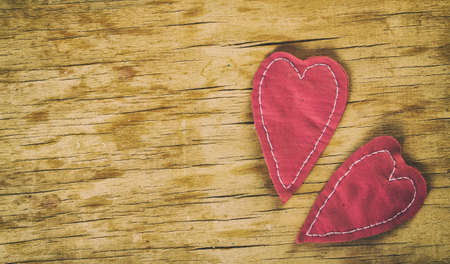 Heart made of cloth on wood desk. Valentine day. Holidays card with copy spaceの写真素材