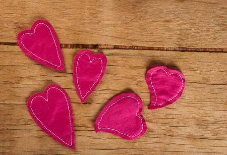 Heart made of cloth on wood desk. Valentine day. Holidays card with copy spaceの写真素材