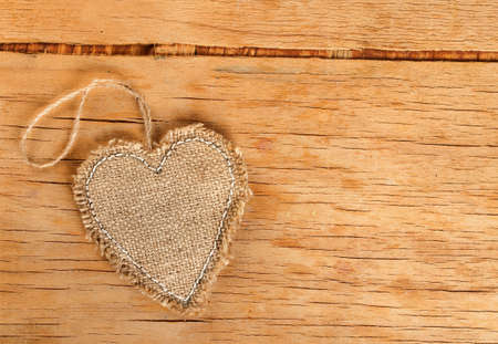 Heart made of cloth on wood desk. Valentine day. Holidays card with copy spaceの写真素材