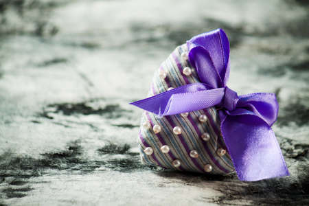 Heart made of cloth on wood desk. Valentine day. Holidays card with copy spaceの写真素材