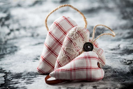 Heart made of cloth on wood desk. Valentine day. Holidays card with copy spaceの写真素材