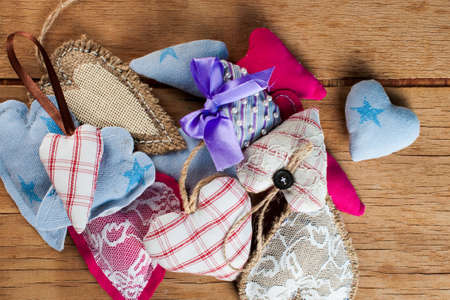 Heart made of cloth on wood desk. Valentine day. Holidays card with copy spaceの写真素材