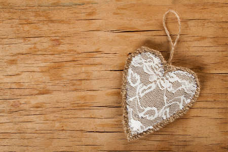 Heart made of cloth on wood desk. Valentine day. Holidays card with copy spaceの写真素材