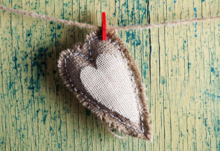 Heart made of cloth on wood desk. Valentine day. Holidays card with copy spaceの写真素材
