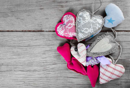 Heart made of cloth on wood desk. Valentine day. Holidays card with copy spaceの写真素材