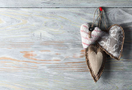 Heart made of cloth on wood desk. Valentine day. Holidays card with copy spaceの写真素材