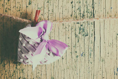 Heart made of cloth on wood desk. Valentine day. Holidays card with copy spaceの写真素材