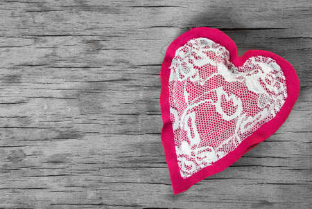 Heart made of cloth on wood desk. Valentine day. Holidays card with copy spaceの写真素材