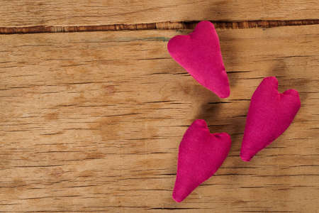 Heart made of cloth on wood desk. Valentine day. Holidays card with copy spaceの写真素材