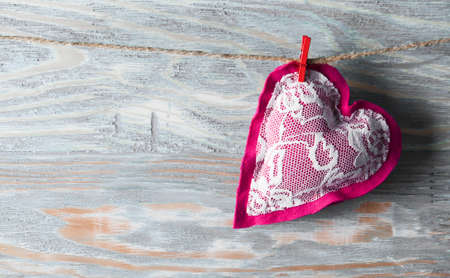Heart made of cloth on wood desk. Valentine day. Holidays card with copy spaceの写真素材