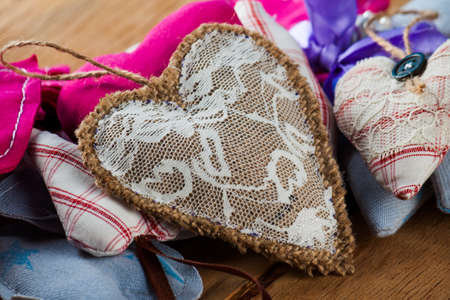 Heart made of cloth on wood desk. Valentine day. Holidays card with copy spaceの写真素材