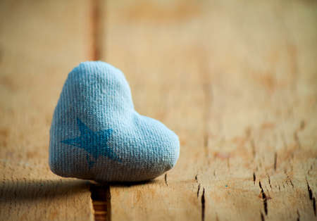 Heart made of cloth on wood desk. Valentine day. Holidays card with copy spaceの写真素材