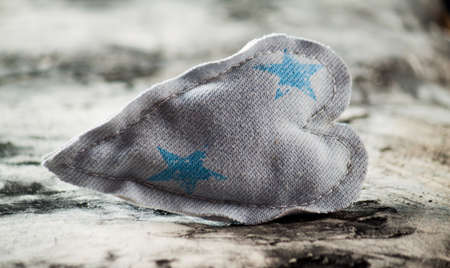 Heart made of cloth on wood desk. Valentine day. Holidays card with copy spaceの写真素材