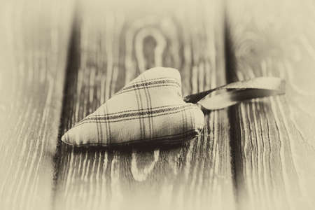 Heart made of cloth on wood desk. Valentine day. Holidays card with copy spaceの写真素材