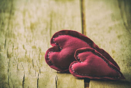 Heart made of cloth on wood desk. Valentine day. Holidays card with copy spaceの写真素材