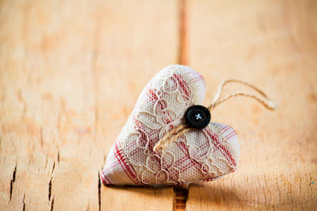 Heart made of cloth on wood desk. Valentine day. Holidays card with copy spaceの写真素材
