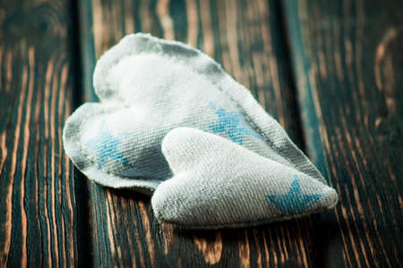 Heart made of cloth on wood desk. Valentine day. Holidays card with copy spaceの写真素材