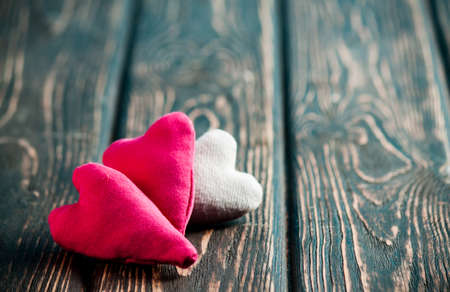 Heart made of cloth on wood desk. Valentine day. Holidays card with copy spaceの写真素材