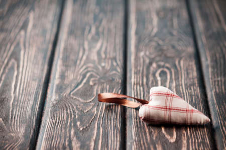 Heart made of cloth on wood desk. Valentine day. Holidays card with copy space