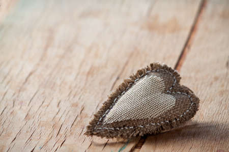 Heart made of cloth on wood desk. Valentine day. Holidays card with copy spaceの写真素材