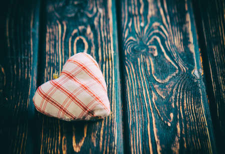 Heart made of cloth on wood desk. Valentine day. Holidays card with copy spaceの写真素材