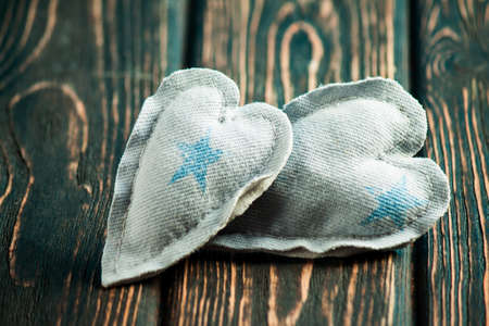 Heart made of cloth on wood desk. Valentine day. Holidays card with copy spaceの写真素材