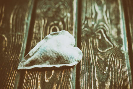 Heart made of cloth on wood desk. Valentine day. Holidays card with copy spaceの写真素材